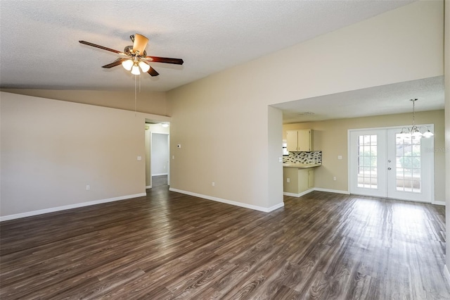 3460 Tomahawk Ave, Spring Hill, FL 34606 - unfurnished living room with dark wood-type flooring, ceiling fan, a textured ceiling, lofted ceiling, and a chandelier