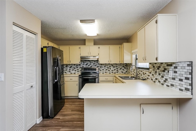 3460 Tomahawk Ave, Spring Hill, FL 34606 - kitchen featuring refrigerator with ice dispenser, stainless steel range with electric cooktop, under cabinet range hood, cream cabinets, and a peninsula