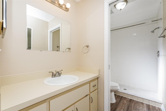 3460 Tomahawk Ave, Spring Hill, FL 34606 - bathroom featuring vanity, tiled shower, and wood finished floors