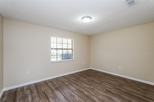 3460 Tomahawk Ave, Spring Hill, FL 34606 - empty room featuring dark wood finished floors and a textured ceiling