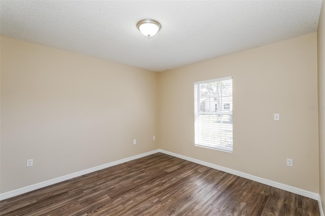 3460 Tomahawk Ave, Spring Hill, FL 34606 - spare room with dark wood-type flooring and baseboards