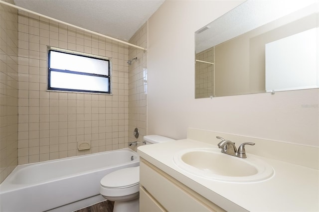 3460 Tomahawk Ave, Spring Hill, FL 34606 - bathroom with vanity, shower / tub combination, a textured ceiling, and wood finished floors
