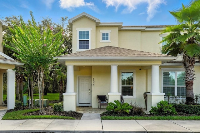 1530 Retreat Cir, Clermont, FL 34714 - view of front of home with a porch, stucco siding, and roof with shingles