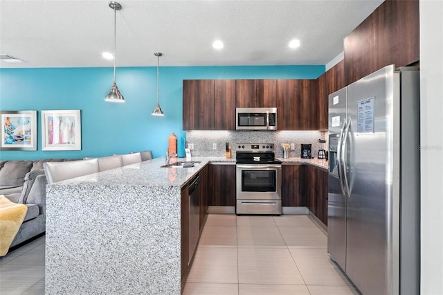 1530 Retreat Cir, Clermont, FL 34714 - kitchen with stainless steel appliances, open floor plan, a peninsula, tasteful backsplash, and light tile patterned floors