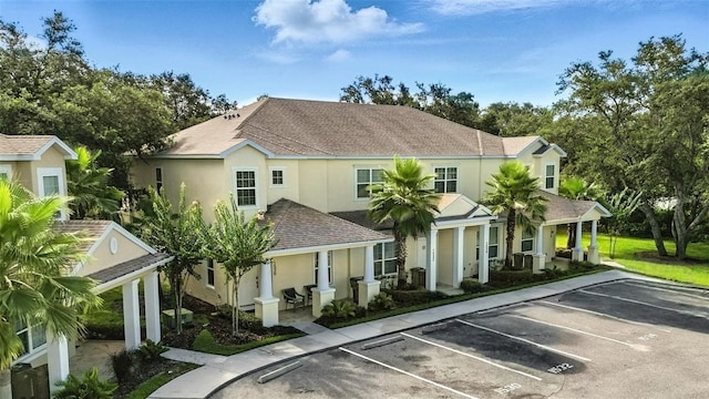 1530 Retreat Cir, Clermont, FL 34714 - view of front of home featuring stucco siding, uncovered parking, covered porch, and roof with shingles