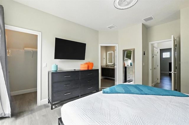 1530 Retreat Cir, Clermont, FL 34714 - bedroom with light wood-style floors, a spacious closet, and a closet