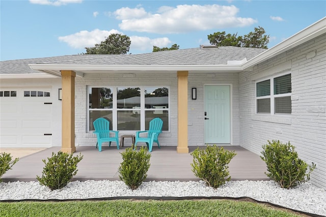 2926 Carriage Dr, South Daytona, FL 32119 - view of exterior entry with brick siding, a shingled roof, an attached garage, and a deck