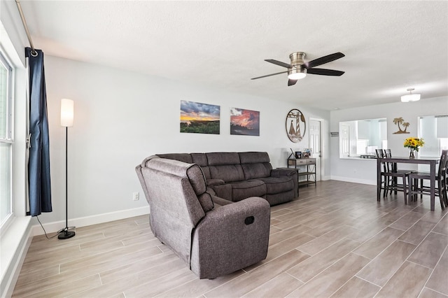 2926 Carriage Dr, South Daytona, FL 32119 - living area featuring light wood-style floors, a ceiling fan, and a textured ceiling