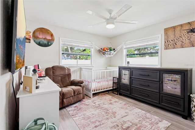 2926 Carriage Dr, South Daytona, FL 32119 - bedroom with light wood finished floors and a ceiling fan