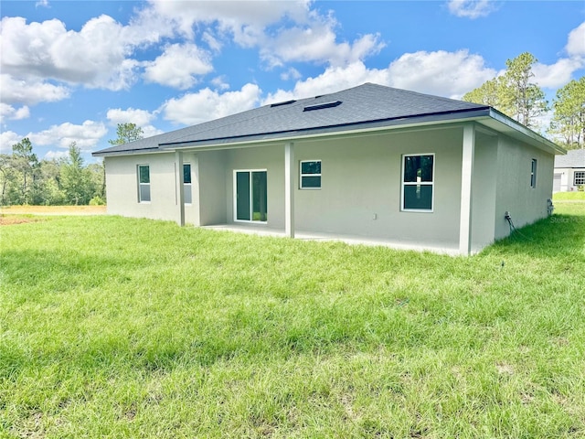 8051 N Pinkinz Way, Citrus Springs, FL 34433 - back of house with a lawn, stucco siding, and roof with shingles