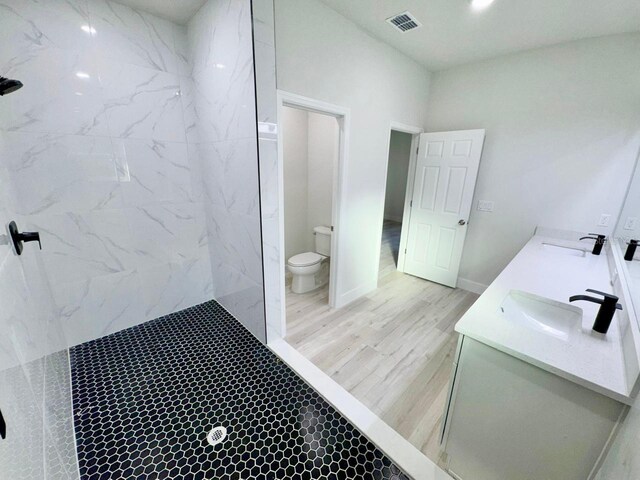 8051 N Pinkinz Way, Citrus Springs, FL 34433 - bathroom with a marble finish shower, double vanity, and wood finished floors