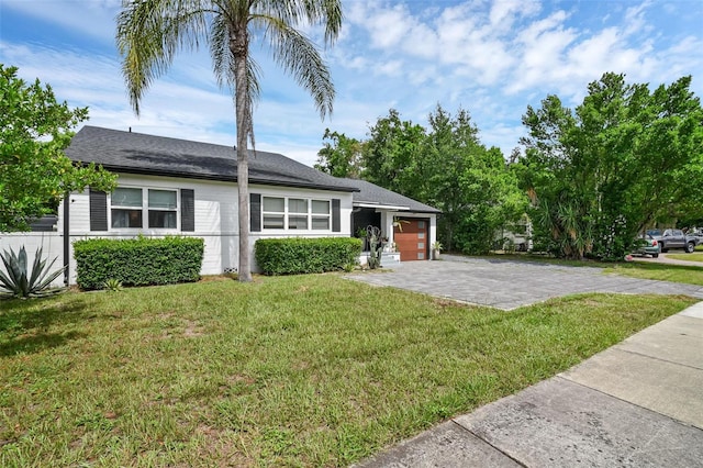 1322 N Bumby Ave, Orlando, FL 32803 - view of front of house with an attached garage, a front lawn, and driveway