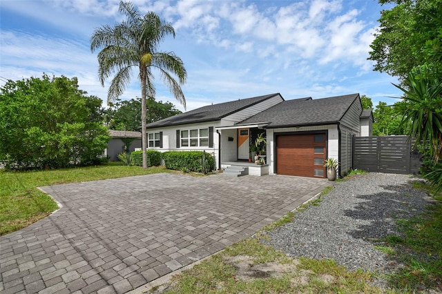 1322 N Bumby Ave, Orlando, FL 32803 - view of front facade featuring driveway, an attached garage, and a shingled roof