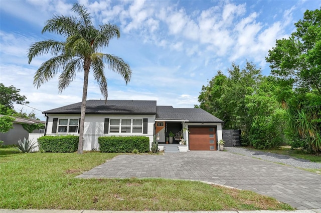 1322 N Bumby Ave, Orlando, FL 32803 - single story home with an attached garage, decorative driveway, and a front yard