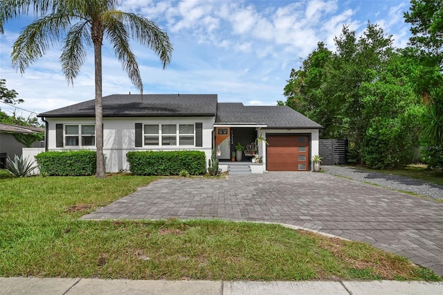1322 N Bumby Ave, Orlando, FL 32803 - view of front of house featuring decorative driveway, a garage, and a front lawn