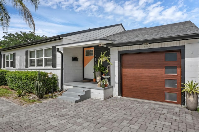 1322 N Bumby Ave, Orlando, FL 32803 - ranch-style house featuring an attached garage, a shingled roof, and decorative driveway