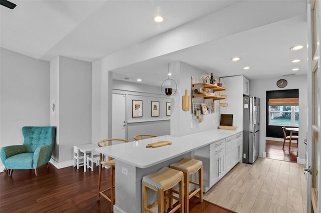 1322 N Bumby Ave, Orlando, FL 32803 - kitchen featuring open shelves, freestanding refrigerator, white cabinets, a peninsula, and recessed lighting