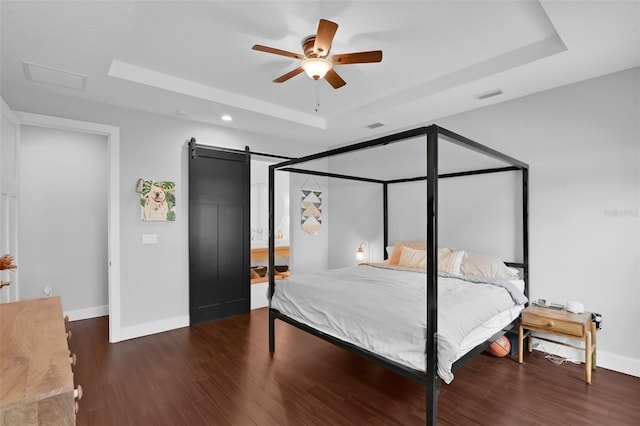 1322 N Bumby Ave, Orlando, FL 32803 - bedroom featuring a raised ceiling, wood finished floors, recessed lighting, a barn door, and attic access