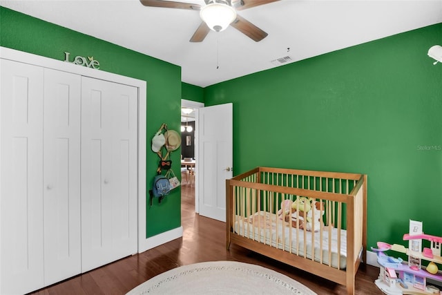 1322 N Bumby Ave, Orlando, FL 32803 - bedroom featuring a closet, a crib, wood finished floors, and a ceiling fan