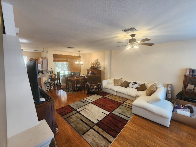2247 Golden Oak Ln, Valrico, FL 33594 - living room featuring a ceiling fan, wood finished floors, and a chandelier
