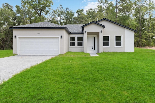 10577 N Umber Ter, Citrus Springs, FL 34434 - view of front of house featuring driveway, a front yard, an attached garage, stucco siding, and roof with shingles