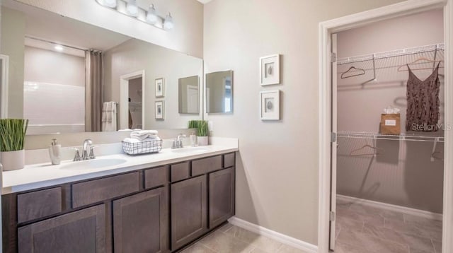1892 NW 248th Way, Newberry, FL 32669 - bathroom featuring double vanity, a walk in closet, and tile patterned flooring