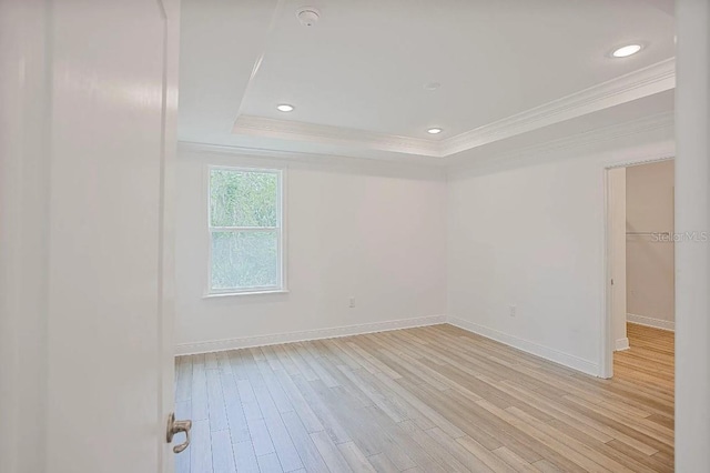 1892 NW 248th Way, Newberry, FL 32669 - empty room featuring crown molding, light wood-style flooring, a raised ceiling, a smoke detector, and recessed lighting