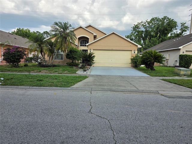 1797 Tillstream Dr, Orlando, FL 32818 - view of front of house featuring concrete driveway, a garage, stucco siding, and a front lawn