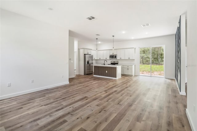 10599 N Umber Ter, Citrus Springs, FL 34434 - unfurnished living room featuring light wood-type flooring and recessed lighting