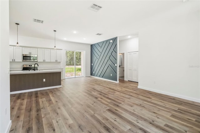 10599 N Umber Ter, Citrus Springs, FL 34434 - living area featuring light wood-type flooring and recessed lighting