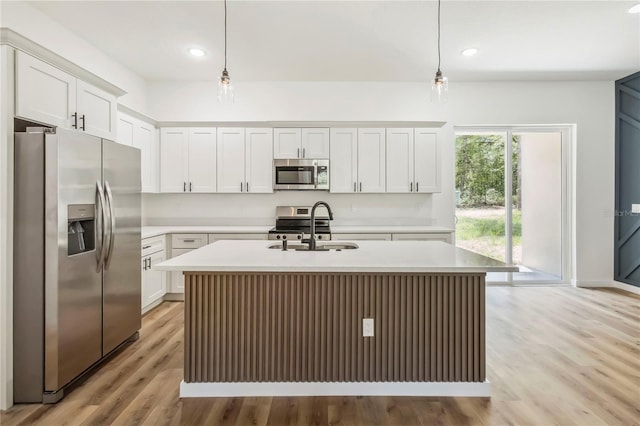 10599 N Umber Ter, Citrus Springs, FL 34434 - kitchen featuring stainless steel appliances, light countertops, pendant lighting, an island with sink, and recessed lighting