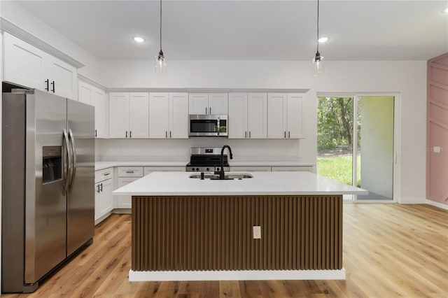 10611 N Umber Ter, Citrus Springs, FL 34434 - kitchen featuring stainless steel appliances, light countertops, decorative light fixtures, a center island with sink, and recessed lighting