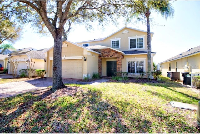 331 Bridgewater Dr, Davenport, FL 33897 - traditional home featuring stucco siding, a garage, driveway, and a front lawn
