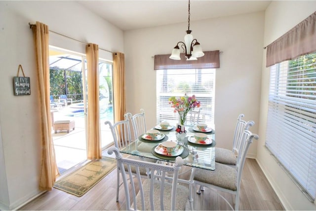 331 Bridgewater Dr, Davenport, FL 33897 - dining room featuring a chandelier and light wood-style flooring
