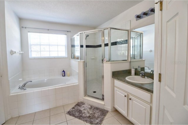 331 Bridgewater Dr, Davenport, FL 33897 - full bathroom featuring vanity, a bath, a stall shower, tile patterned floors, and a textured ceiling