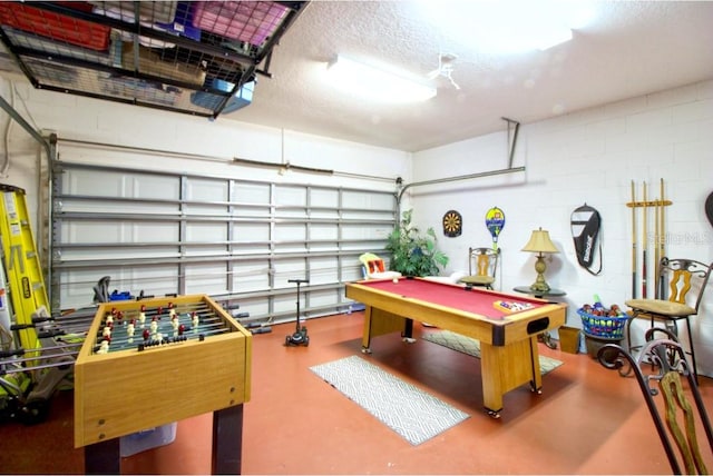 331 Bridgewater Dr, Davenport, FL 33897 - game room featuring a garage, concrete floors, concrete block wall, billiards table, and a textured ceiling