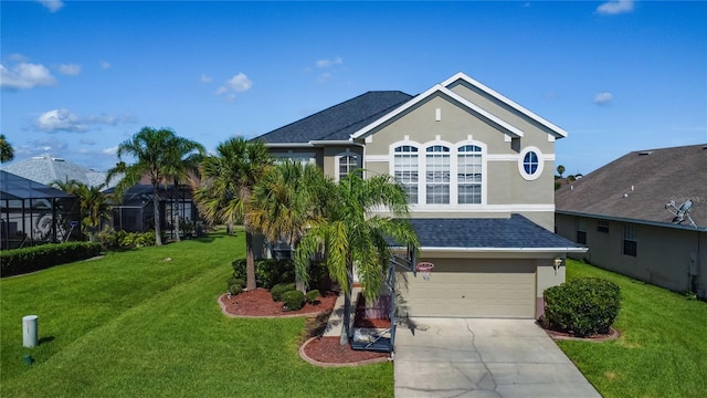 2530 The Oaks Blvd, Kissimmee, FL 34746 - view of front of home with stucco siding, an attached garage, driveway, a front yard, and roof with shingles