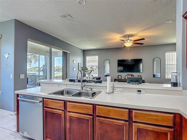 2530 The Oaks Blvd, Kissimmee, FL 34746 - kitchen featuring open floor plan, light countertops, a ceiling fan, stainless steel dishwasher, and a textured ceiling