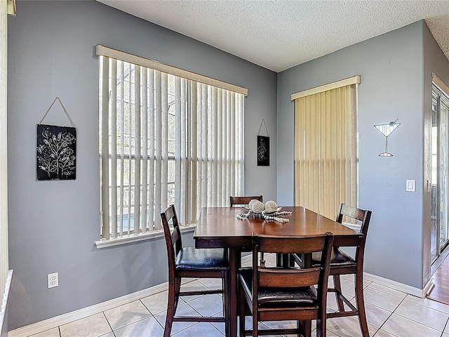 2530 The Oaks Blvd, Kissimmee, FL 34746 - dining area with light tile patterned flooring and a textured ceiling