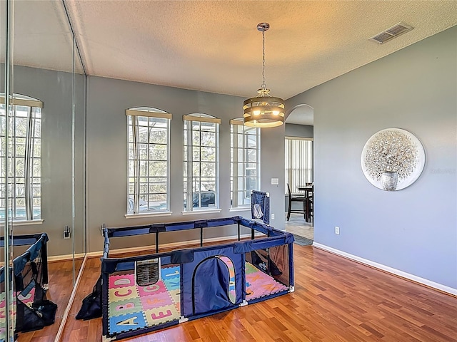 2530 The Oaks Blvd, Kissimmee, FL 34746 - dining room with wood finished floors, plenty of natural light, arched walkways, and a textured ceiling