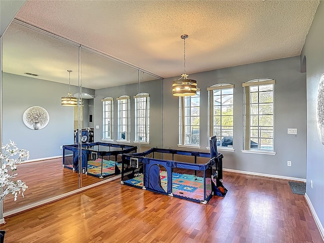 2530 The Oaks Blvd, Kissimmee, FL 34746 - dining room featuring wood finished floors and a textured ceiling