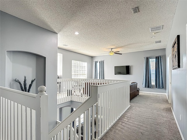 2530 The Oaks Blvd, Kissimmee, FL 34746 - hall featuring an upstairs landing, carpet flooring, a textured ceiling, healthy amount of natural light, and recessed lighting