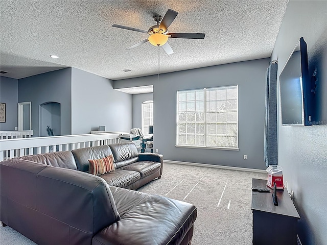 2530 The Oaks Blvd, Kissimmee, FL 34746 - carpeted living room with a ceiling fan, plenty of natural light, and a textured ceiling