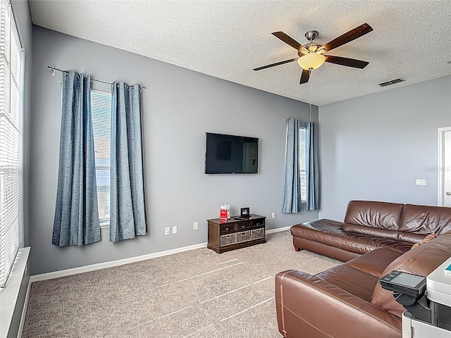 2530 The Oaks Blvd, Kissimmee, FL 34746 - carpeted living room with a ceiling fan and a textured ceiling