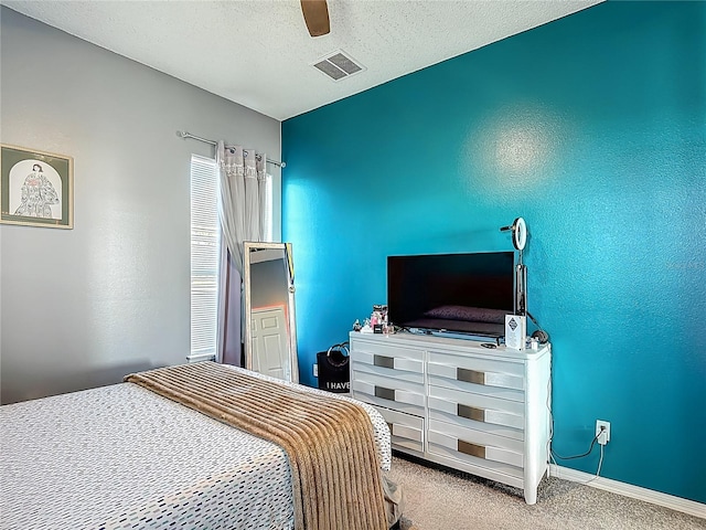 2530 The Oaks Blvd, Kissimmee, FL 34746 - carpeted bedroom with a ceiling fan and a textured ceiling
