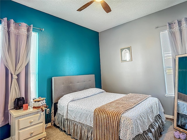 2530 The Oaks Blvd, Kissimmee, FL 34746 - bedroom featuring carpet floors, a ceiling fan, and a textured ceiling