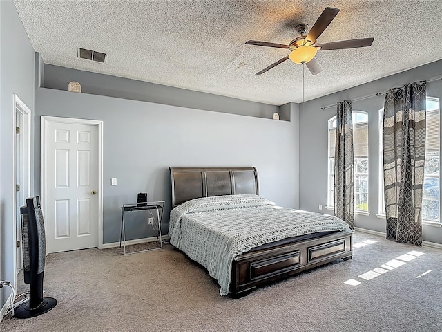 2530 The Oaks Blvd, Kissimmee, FL 34746 - carpeted bedroom featuring a textured ceiling and ceiling fan