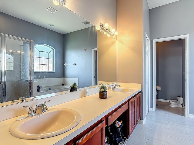 2530 The Oaks Blvd, Kissimmee, FL 34746 - bathroom with a garden tub, double vanity, a shower stall, and tile patterned floors