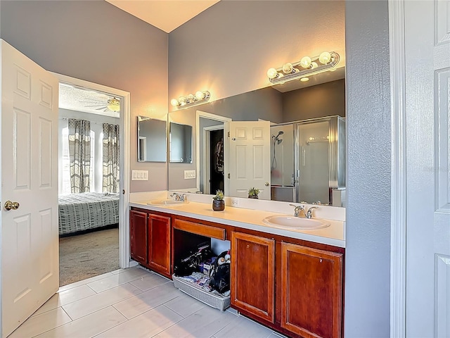 2530 The Oaks Blvd, Kissimmee, FL 34746 - full bathroom with double vanity, a shower stall, tile patterned floors, and connected bathroom