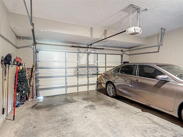 2530 The Oaks Blvd, Kissimmee, FL 34746 - garage featuring a garage door opener and concrete block wall